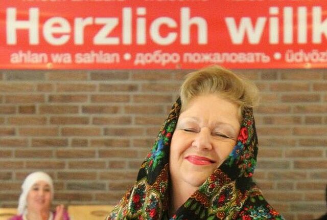 Eine FRau aus dem Zentrum plus lacht in die KAmera